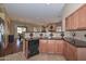 Kitchen area view, with breakfast bar and open sightlines into dining and living areas at 2116 E Beautiful Ln, Phoenix, AZ 85042