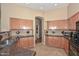 Beautiful kitchen featuring tiled backsplash, granite countertops, and ample cabinet space at 2116 E Beautiful Ln, Phoenix, AZ 85042