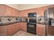 Modern kitchen features stainless steel appliances, granite counters, and lots of cabinets at 2116 E Beautiful Ln, Phoenix, AZ 85042