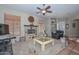 Comfortable living room featuring a fireplace, ceiling fan and lots of natural lighting at 2116 E Beautiful Ln, Phoenix, AZ 85042