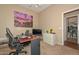 Bright office with a desk, computer, and a view into an adjacent bathroom at 2116 E Beautiful Ln, Phoenix, AZ 85042