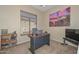Office featuring a neutral color scheme, desk with laptop, and large window at 2116 E Beautiful Ln, Phoenix, AZ 85042