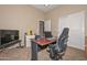 Well-lit office space with neutral walls, a functional desk and a comfortable chair at 2116 E Beautiful Ln, Phoenix, AZ 85042
