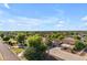 Aerial of a desert home in a residential area with a garage and large, well-maintained yard at 21470 E Orchard Ln, Queen Creek, AZ 85142
