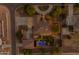 An aerial view of a property with a landscaped circular driveway, backyard pool, and outdoor fireplace at 21470 E Orchard Ln, Queen Creek, AZ 85142