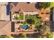 An aerial view shows a private backyard with a swimming pool, outdoor fireplace, landscaping, and play structure at 21470 E Orchard Ln, Queen Creek, AZ 85142