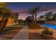 Sprawling backyard with mature trees, pool, and an exterior patio area at 21470 E Orchard Ln, Queen Creek, AZ 85142