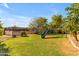 Backyard with a green lawn, gardening area, mature landscaping, and a playset at 21470 E Orchard Ln, Queen Creek, AZ 85142
