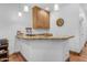 Stylish bar area with light wood cabinets and granite countertops for entertaining at 21470 E Orchard Ln, Queen Creek, AZ 85142