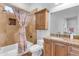 Well-lit bathroom features a shower and tub combination, vanity with stone countertop, and a neutral color palette at 21470 E Orchard Ln, Queen Creek, AZ 85142