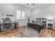 bedroom featuring hardwood floors, a decorative rug, and a desk and bed at 21470 E Orchard Ln, Queen Creek, AZ 85142