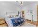Bedroom featuring hardwood floors, natural light, and a Montana State themed blanket at 21470 E Orchard Ln, Queen Creek, AZ 85142