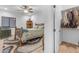 Charming bedroom with stylish rustic bed, hardwood floors and a ceiling fan at 21470 E Orchard Ln, Queen Creek, AZ 85142