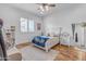 Bedroom with a large window, hardwood floors, and a bed with a Montana State blanket at 21470 E Orchard Ln, Queen Creek, AZ 85142