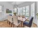 Bright dining room with custom lighting, large windows, and hardwood table with seating for six at 21470 E Orchard Ln, Queen Creek, AZ 85142