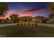 Front of home with manicured lawn, circular driveway, stone accents at twilight at 21470 E Orchard Ln, Queen Creek, AZ 85142