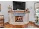 Close-up of fireplace with decorative tile and wood mantle at 21470 E Orchard Ln, Queen Creek, AZ 85142