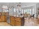 Kitchen featuring breakfast bar seating, and stainless steel appliances with open dining area at 21470 E Orchard Ln, Queen Creek, AZ 85142