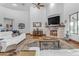 Large living room with fireplace, hardwood floors, and high ceilings at 21470 E Orchard Ln, Queen Creek, AZ 85142