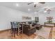 Entertaining living room space features a leather sectional sofa, bar area, hardwood floors, and neutral colors at 21470 E Orchard Ln, Queen Creek, AZ 85142