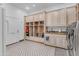 Large mud room with washer and dryer, custom cabinetry, mud bench, coat hooks, and decorative tiled floors at 21470 E Orchard Ln, Queen Creek, AZ 85142