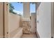 A secluded outdoor shower with stone accents, offering a refreshing and private bathing experience at 21470 E Orchard Ln, Queen Creek, AZ 85142