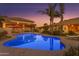 Outdoor pool and patio area perfect for evening relaxation and entertaining at 21470 E Orchard Ln, Queen Creek, AZ 85142