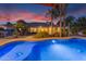 Beautiful backyard pool with lush landscaping and exterior view of home at 21470 E Orchard Ln, Queen Creek, AZ 85142