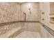 Tile shower with built-in bench and multiple shower heads in the bathroom at 21470 E Orchard Ln, Queen Creek, AZ 85142
