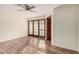 Bright bedroom featuring hardwood floors, ceiling fan, large windows with wooden trim at 2201 W Union Hills Dr # 119, Phoenix, AZ 85027