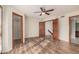 Spacious bedroom features wood floors, ceiling fan, closet, and entry to the bathroom and stairway at 2201 W Union Hills Dr # 119, Phoenix, AZ 85027