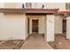Low angle view of tan home exterior with tile roof and front walkway with desert landscaping at 2201 W Union Hills Dr # 119, Phoenix, AZ 85027