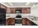 The kitchen has matching wooden cabinetry, stone countertops, and stainless steel appliances at 2201 W Union Hills Dr # 119, Phoenix, AZ 85027