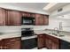 The kitchen has matching wooden cabinetry, stone countertops, and stainless steel appliances at 2201 W Union Hills Dr # 119, Phoenix, AZ 85027