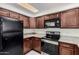 The kitchen has matching wooden cabinetry, stone countertops, and stainless steel appliances at 2201 W Union Hills Dr # 119, Phoenix, AZ 85027