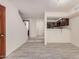 Open-concept living room featuring sleek tile floors and staircase leading to the second level at 2201 W Union Hills Dr # 119, Phoenix, AZ 85027