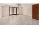 Open-concept living room with tile floors and doors leading to the outside area at 2201 W Union Hills Dr # 119, Phoenix, AZ 85027