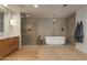 Modern bathroom features a soaking tub, separate glass shower, and wood vanity at 2211 E Camelback Rd # 402, Phoenix, AZ 85016