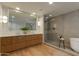 Spacious bathroom featuring a large mirror, double sink vanity, and a glass enclosed shower at 2211 E Camelback Rd # 402, Phoenix, AZ 85016