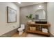 Unique bathroom with a modern vessel sink and arched mirror, accented with stylish decor at 2211 E Camelback Rd # 402, Phoenix, AZ 85016