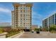 Modern high-rise building with manicured landscaping, offering luxury living in a prime location at 2211 E Camelback Rd # 402, Phoenix, AZ 85016