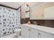 Well-lit bathroom features a single vanity, a mirror, and a shower with a decorative curtain at 2306 E Burgess Ln, Phoenix, AZ 85042