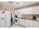 Functional kitchen with white appliances, plenty of counter space, and ample storage at 2306 E Burgess Ln, Phoenix, AZ 85042