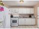 Well-lit kitchen featuring modern appliances and efficient layout for easy cooking at 2306 E Burgess Ln, Phoenix, AZ 85042
