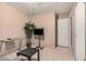 Cozy living room features a glass desk, TV and decorative potted plant at 2306 E Burgess Ln, Phoenix, AZ 85042