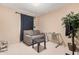 Comfortable living room featuring a gray couch, desk, and decorative potted plant at 2306 E Burgess Ln, Phoenix, AZ 85042