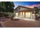 Beautiful backyard with covered patio, desert landscaping, and lush tree providing shade at 2313 E Gondola Ln, Gilbert, AZ 85234