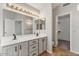 Bathroom with double sinks and a vanity with views into the walk-in closet and the toilet at 2313 E Gondola Ln, Gilbert, AZ 85234