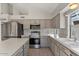 The modern kitchen features stainless steel appliances and grey cabinets at 2313 E Gondola Ln, Gilbert, AZ 85234