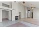Bright living room with tile floors, vaulted ceilings, and a cozy fireplace at 2313 E Gondola Ln, Gilbert, AZ 85234